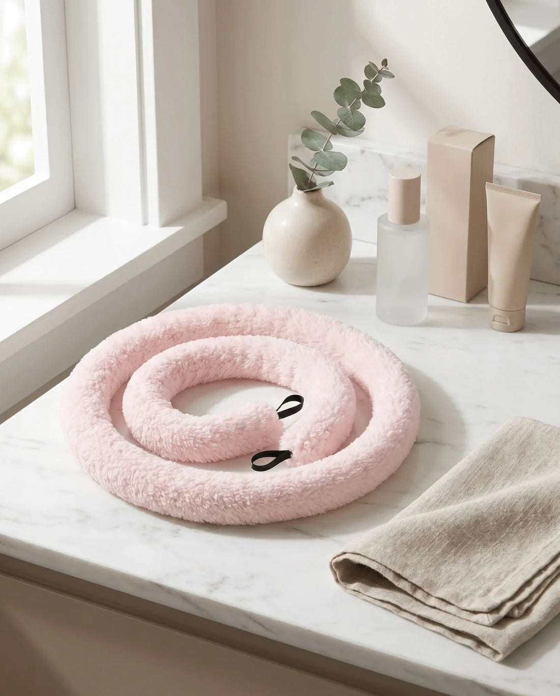Pink fluffy heatless curler on marble vanity, no heat hair styling tool for bouncy curls